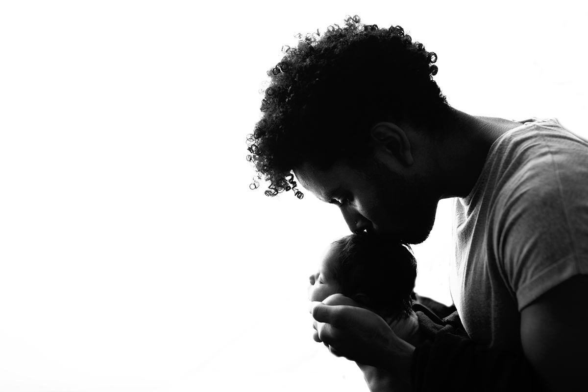 silhouette of dad and baby newborn photo shoot