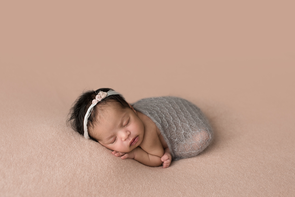 baby in grey blanket during studio photo session