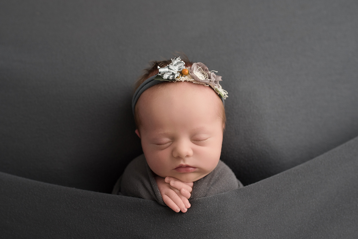 newborn in tucked in pose