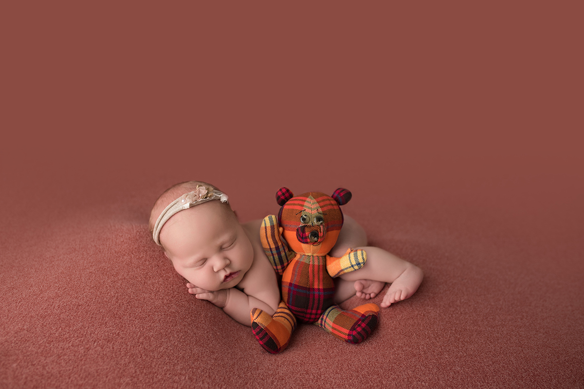 newborn with stuffed animal