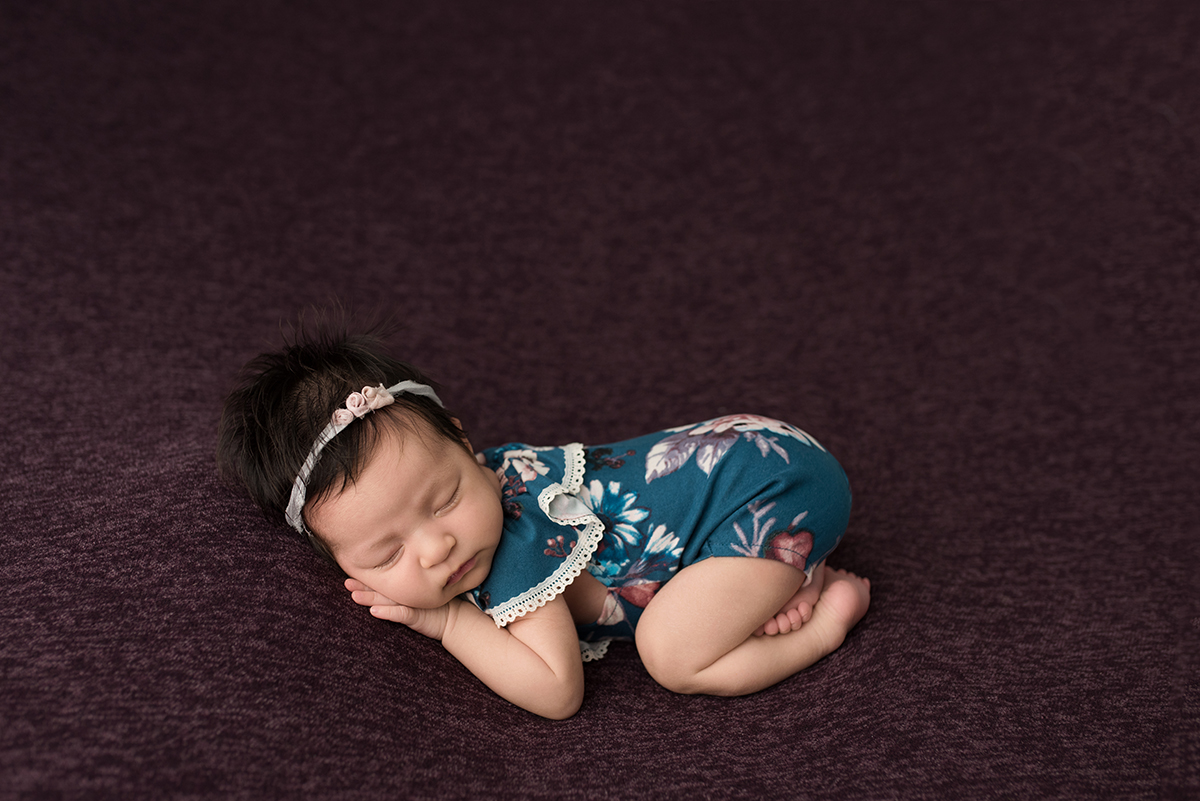 posed newborn in bottoms up pose