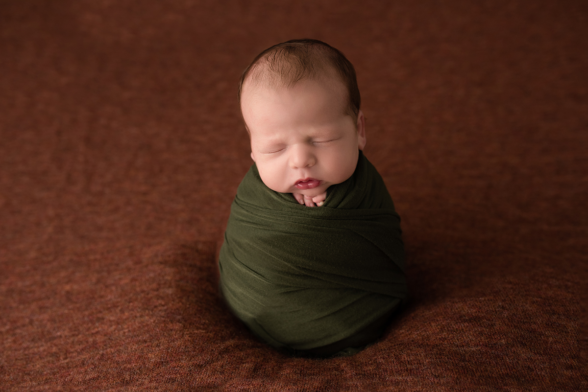 newborn in potato sack pose