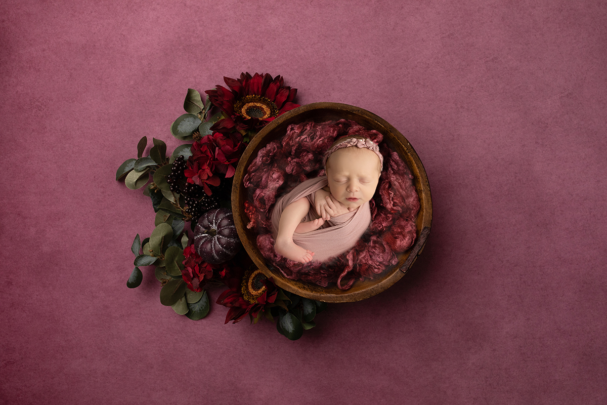 Newborn in bowl with flowers