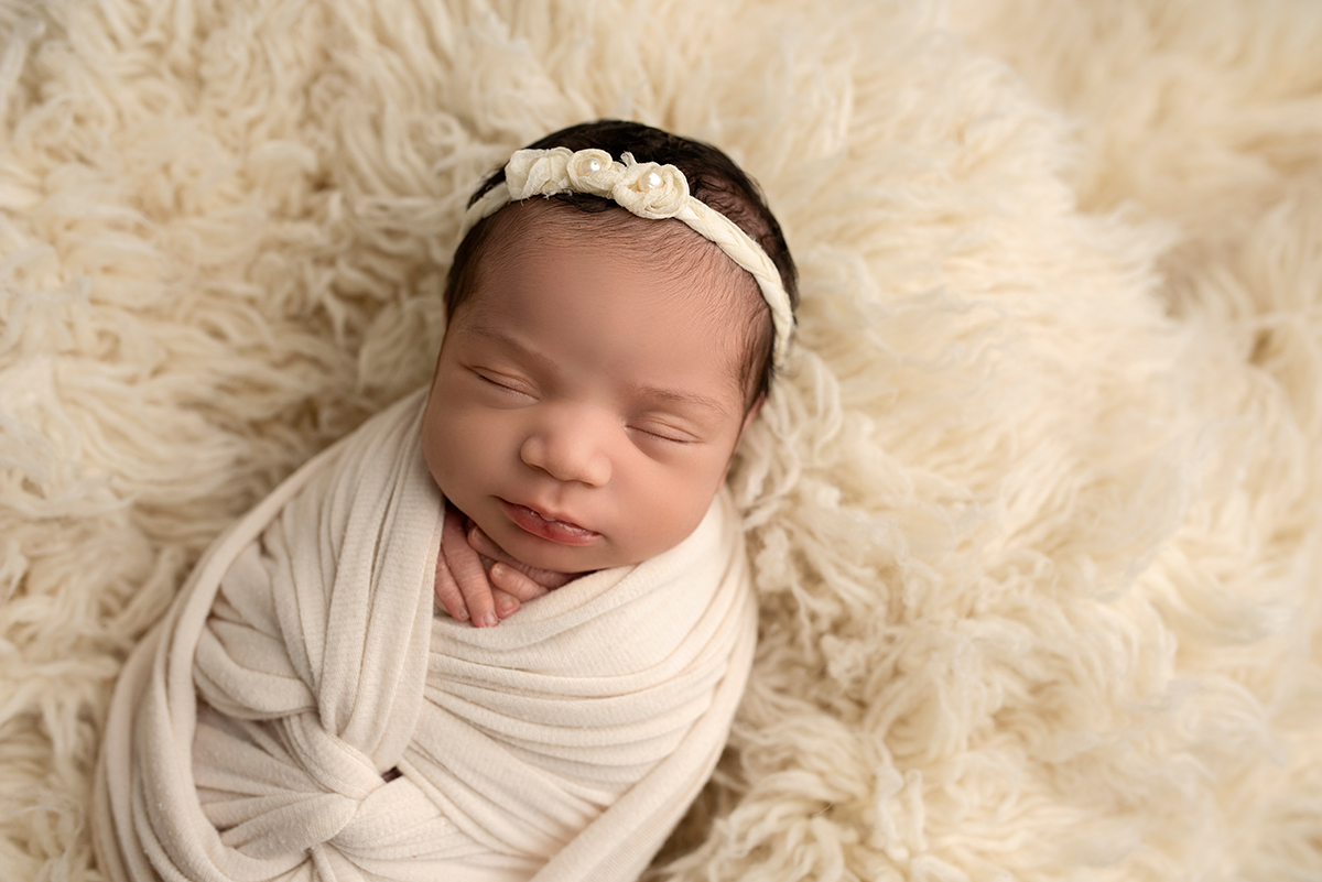 newborn wrapped in swaddle