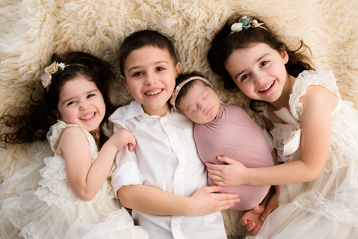 siblings with newborn during photo session