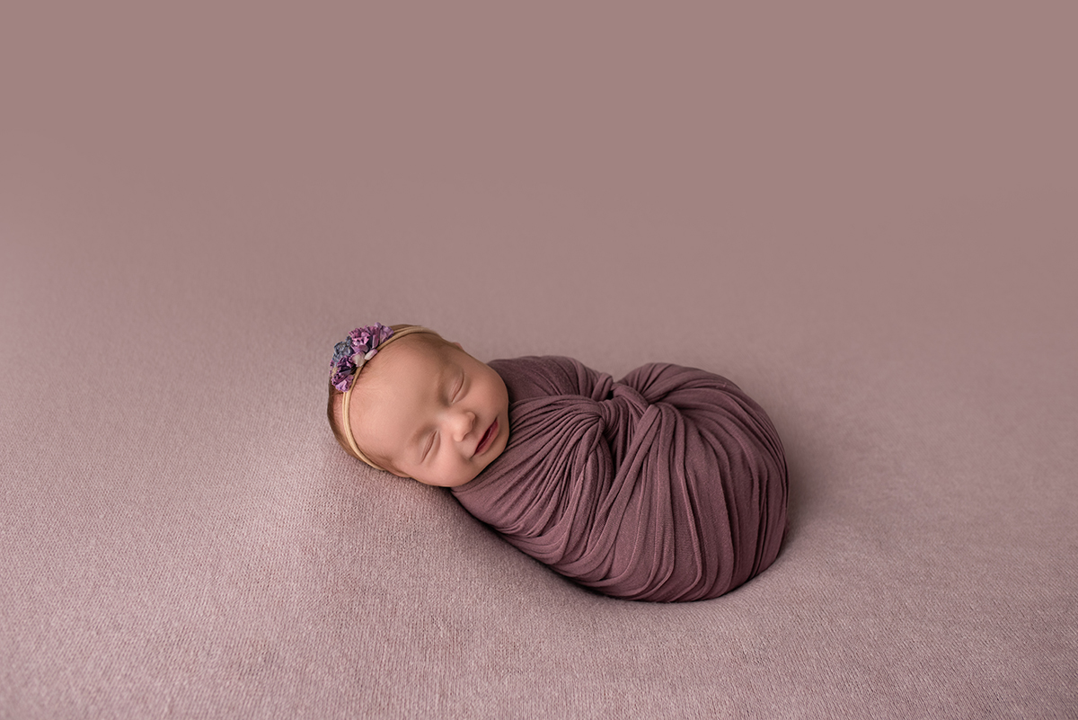 newborn swaddled in blanket