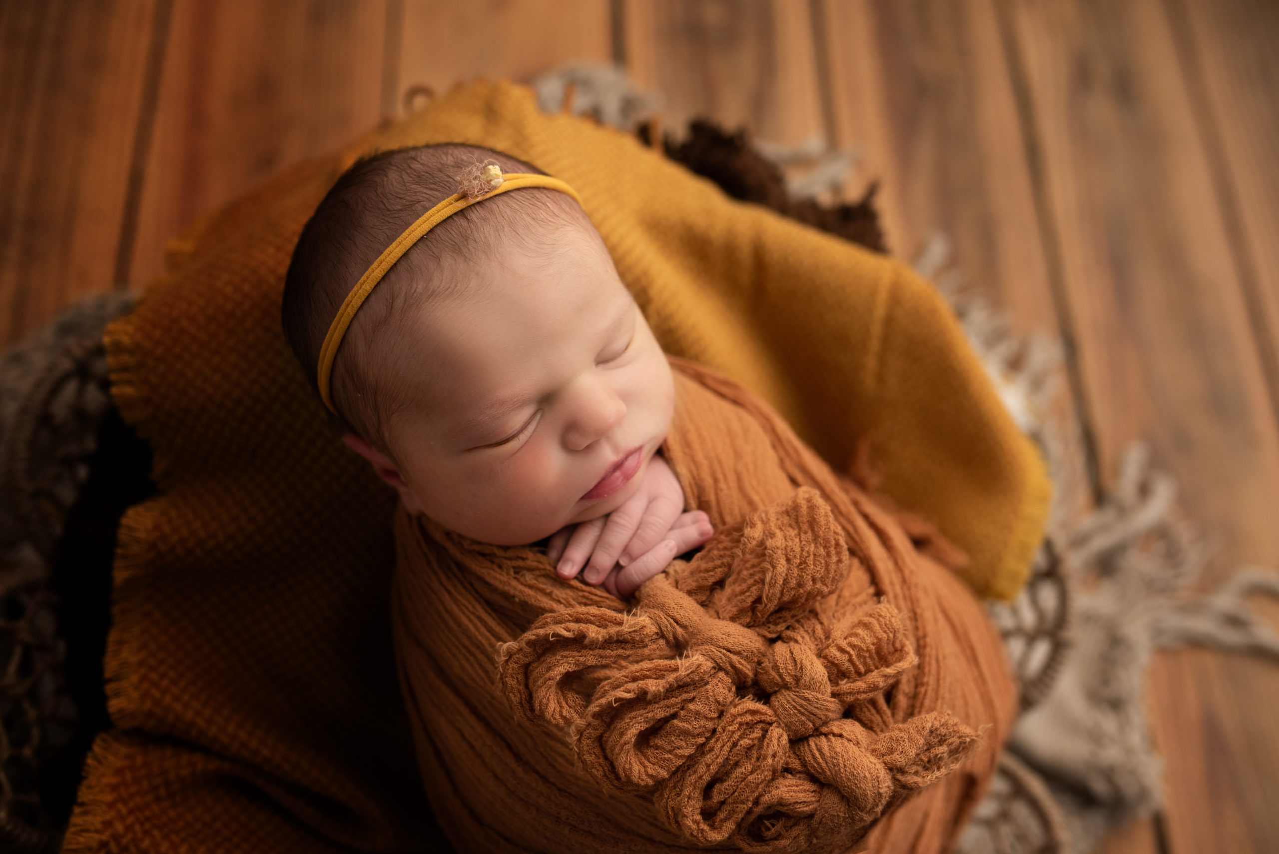 newborn wrapped in swaddle during newborn photo session