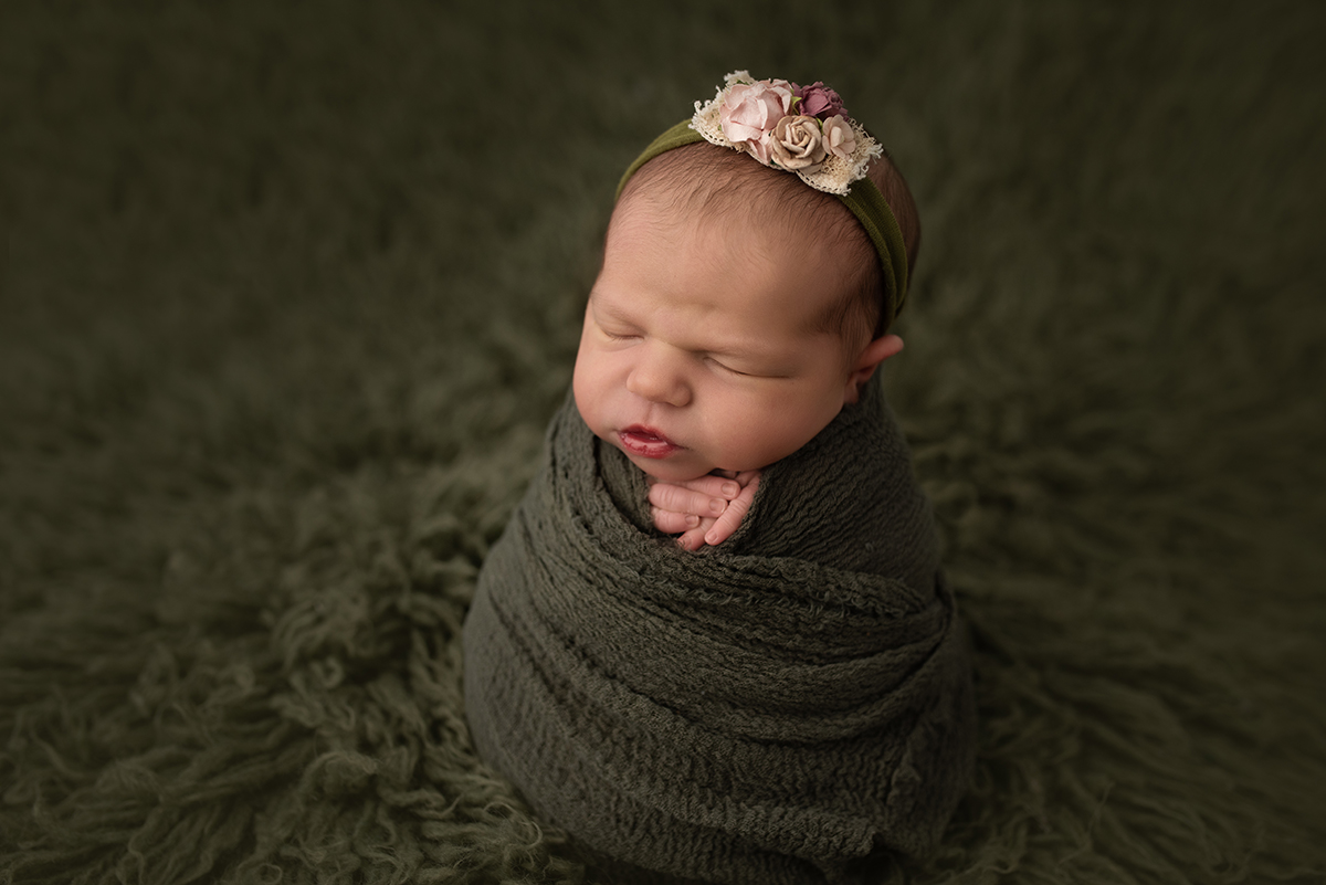 newborn swaddled in potato sack pose