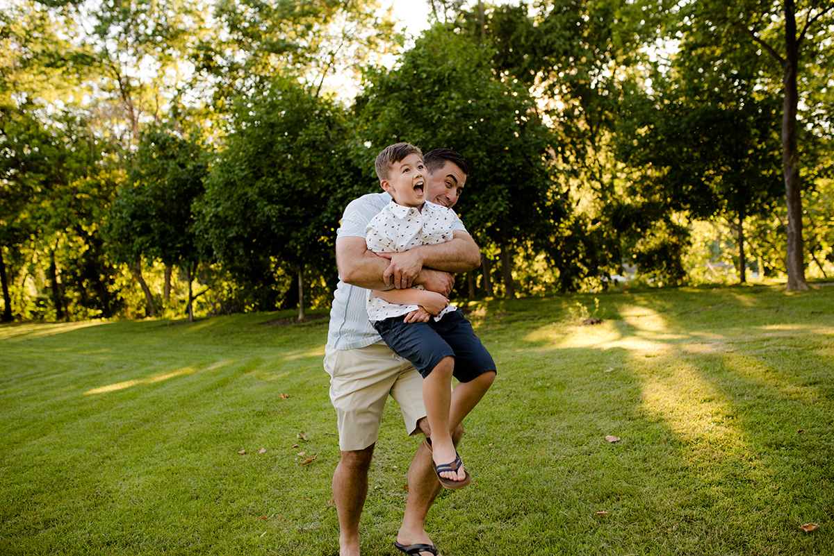 dad carrying son during fun family photo session