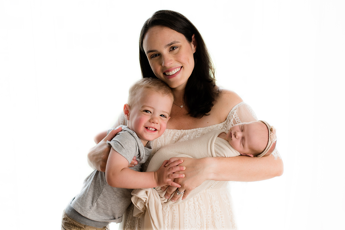 Mom with newborn and son in photography studio